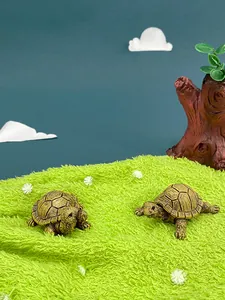 Detailed close-up of resin turtle figurines with realistic texture on a lush green lawn