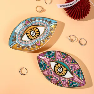 Detailed view of evil eye ceramic jewelry trays with gold edges and mandala patterns