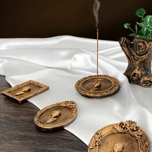 Vintage gold incense burner set with tulip relief and tree stump vase on silk background