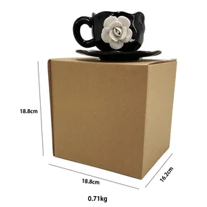 Macro view of black ceramic coffee mug with 3D white rose petal flower and saucer