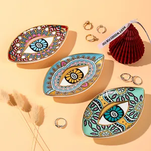 Detailed top view of ceramic Evil Eye jewelry trays with gold rim in three colors