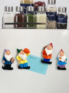 Set of 4 cute resin garden gnome fridge magnets showing strong magnetic hold on white surface