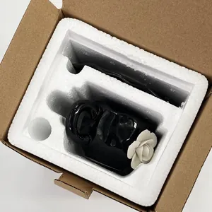 Top view of 3D white rose ceramic cup in protective foam and brown cardboard box