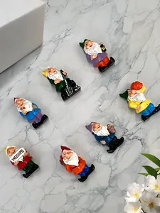Detailed view of seven colorful resin garden gnomes with welcome sign and tools