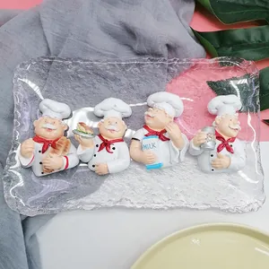 Set of four chef resin figurines on a textured glass tray with diverse culinary poses