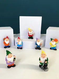 Close-up of colorful resin garden gnome fridge magnets featuring a Welcome sign and tools