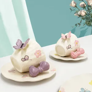 Set tazzina e piattino in ceramica con manico a fiocco 3D e motivi floreali a farfalla