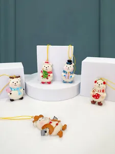 Detailed view of five white resin Christmas bears with colorful holiday accessories