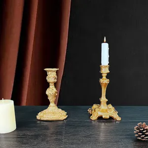 Detail of vintage Baroque gold candlesticks with intricate embossed floral carvings