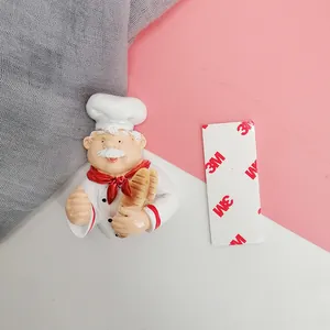 Detail of cute resin chef plug holder with 3M adhesive tape for wall mounting