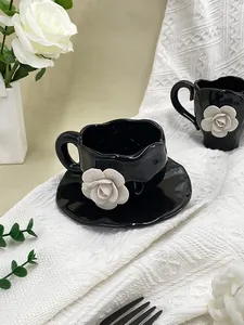 Macro shot of 3D white ceramic camellia flower relief on black irregular coffee cup