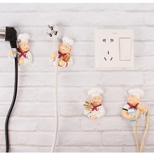 Creative chef power plug holder set of four hooks on a white brick wall background