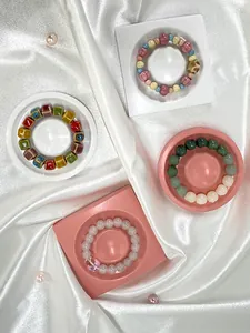 Detailed view of various beaded bracelets showcased on elegant jewelry display trays