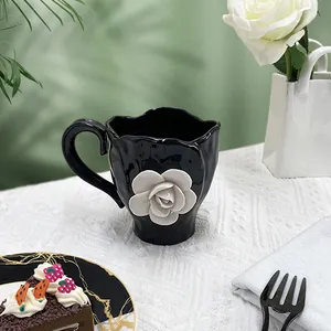 3D white rose ceramic coffee cup with black glaze and petal embossed details for tea