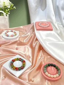 Detail view of colorful bohemian beaded bracelets on elegant silk display trays