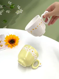 Detailed close-up of a ceramic daisy mug with 3D embossed flower patterns and unique handle