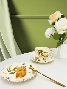 Detail of vintage ceramic tea set with lemon and floral patterns and gold rims