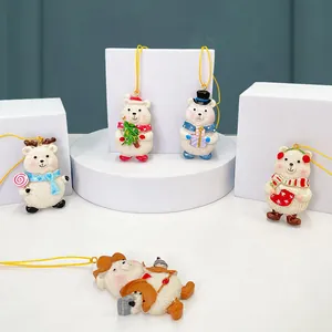 Set of 5 festive white resin Christmas bear ornaments with colorful holiday accessories
