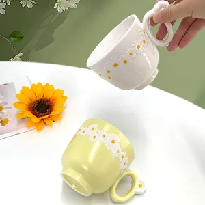 Handmade ceramic daisy coffee mug with floral handle and 3D embossed flower details