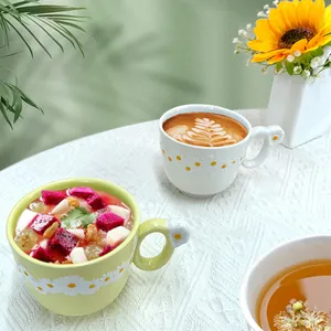Ceramic daisy coffee mug with 3D flower relief and unique floral handle on lace