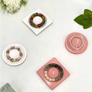 Bohemian style beaded bracelets in various colors displayed on geometric jewelry trays