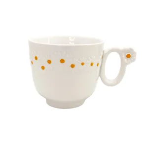 White ceramic daisy coffee mug with embossed flower patterns and a creative 3D handle