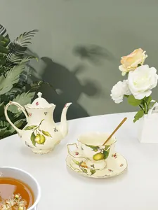 Detail view of vintage ceramic tea set with lemon pattern and elegant gold trim