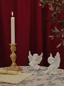 Baroque style gold candle holder with carved details and cute white cupid angel statues