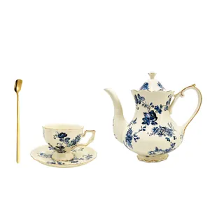 Set da tè vintage in ceramica con rose blu, teiera e tazza con eleganti bordi dorati