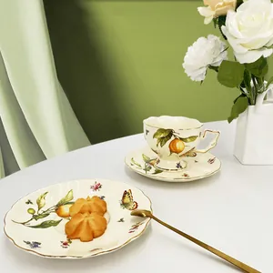 European vintage ceramic tea set with lemon and floral patterns and golden rim details