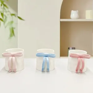 Ceramic coffee mugs with 3D handmade bows in pastel pink, blue and cream colors