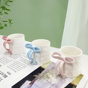 3D bow handle ceramic coffee mugs with irregular wave texture in pink, blue and purple
