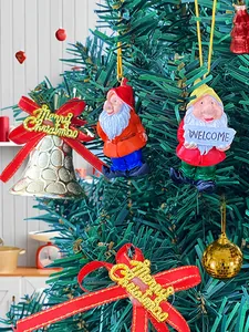 Detail of Christmas dwarf resin ornament with Merry Christmas bow and festive bell
