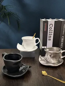 Artistic face-shaped ceramic coffee cup set with metallic mirror finish and golden spoon