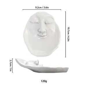 Detailed top and side view of white abstract face resin jewelry tray showing dimensions
