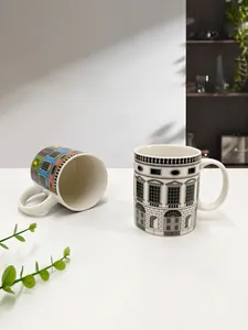 Detailed view of ceramic mugs with vintage Italian architecture patterns and white glaze