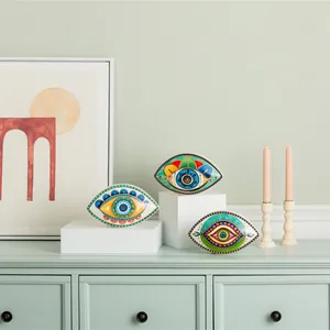Detalle de adornos de cerámica Evil Eye pintados a mano en una estantería