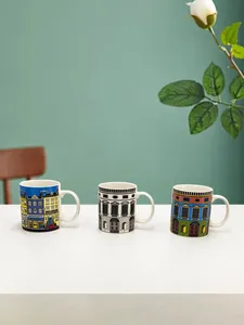 Three Italian-style ceramic mugs featuring vintage architectural illustrations on a table