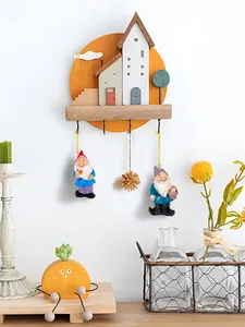 Detailed wall-mounted resin gnome village hook with colorful miniatures and orange wood base