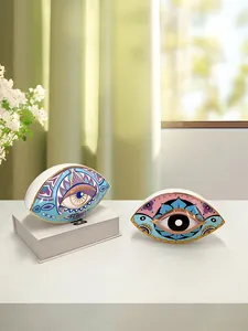 Detailed close-up of ceramic Evil Eye ornaments with gold rim and artistic patterns