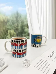 Detailed view of ceramic mugs with British guard and Italian architecture art patterns
