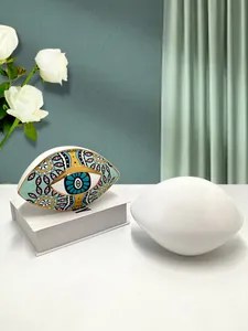 Detailed view of evil eye ceramic ornaments with gold-rimmed glaze for home decor