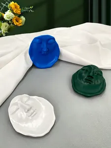 Abstract face-shaped resin art trays in blue, green, and white for home decor