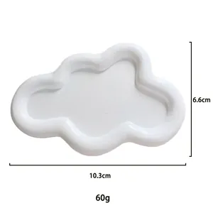 Macro detail of cloud-shaped white resin jewelry tray with dimensions 10.3cm x 6.6cm