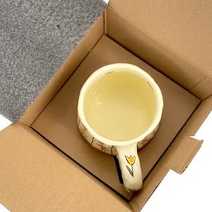 Top view of cream ceramic tulip coffee mug in its protective foam packaging box