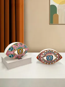 Macro detail of ceramic evil eye ornaments with gold trim and mandala patterns