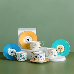 Set tazzine da caffè in ceramica Occhio del Male con manici dorati e piattini dai colori vivaci