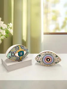 Detail of Nordic ceramic evil eye ornaments with gold edges and bohemian patterns