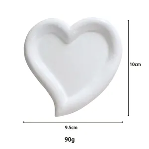 Detail view of heart-shaped resin jewelry tray showing 10cm by 9.5cm dimensions