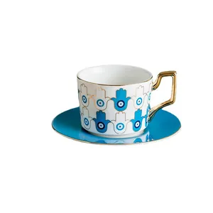 Set tazzina da caffè e piattino in ceramica blu con motivi hamsa e malocchio dorati